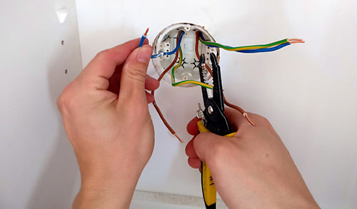 Electrician clipping wires.
